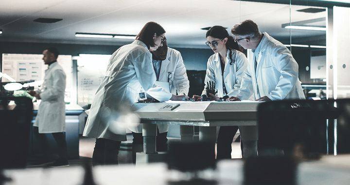 Team of scientists in lab coats collaborating on advanced research and innovation at a modern laboratory