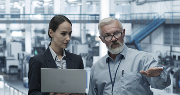 Factory experts reviewing performance metrics to ensure smooth ramp-up optimization during new production setup with LG support.