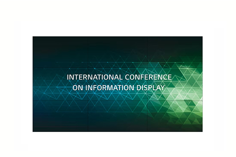 A digital display screen showing the text “INTERNATIONAL CONFERENCE ON INFORMATION DISPLAY” over a green and blue geometric background.