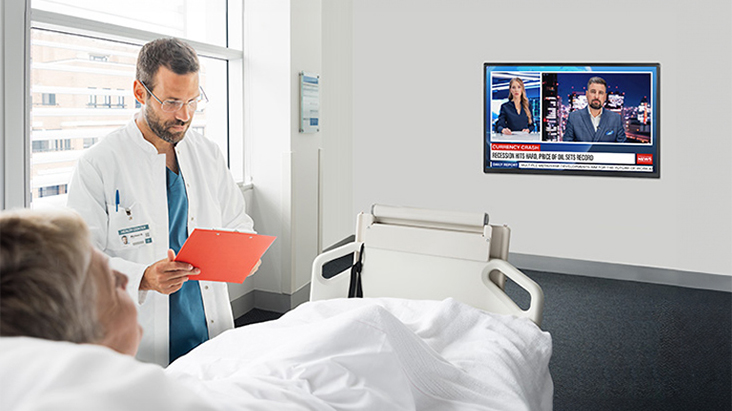 An LG commercial TV is installed in a hospital room.