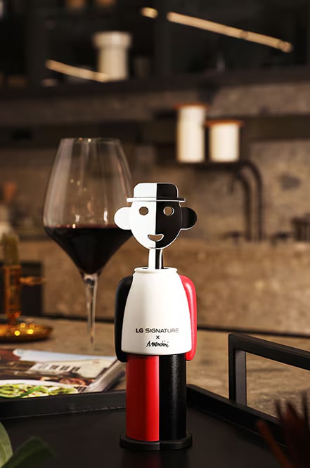 LG SIGNATURE corkscrew by Alessandro Mendini with a glass of wine.