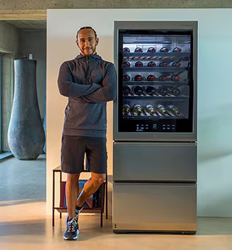 Lewis Hamilton leaning against the LG SIGNATURE Wine Cellar.