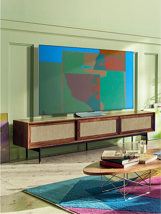 En una colorida sala de estar con muebles de madera y plantas hay un televisor LG OLED con soporte giratorio. En una habitación gris y abstracta hay un televisor LG OLED con soporte giratorio.