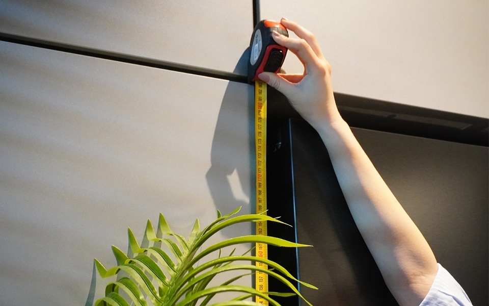 A man measuring his refrigerator size