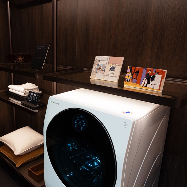 The LG SIGNATURE washing machine is showcased as part of an exhibition, shown placed in a closet space.