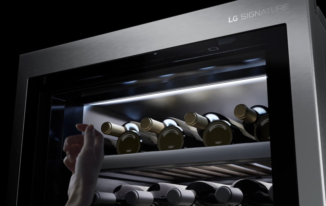 The LG SIGNATURE Refrigerator with lit glass door allowing you to see inside.