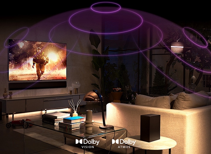 An image of an LG OLED TV in a room playing an action movie. Sound waves create a dome between the sofa and the TV, depicting immersive spatial audio.