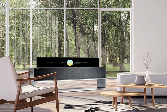 A wide view of the living room with LG SIGNATURE Rollable OLED TV in line view.