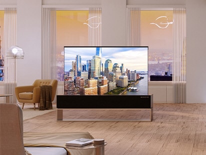 A wide view of the kitchen and the living room with LG SIGNATURE Rollable OLED TV in full view.