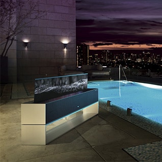 Luxurious swimming pool with the LG SIGNATURE Rollable OLED TV.