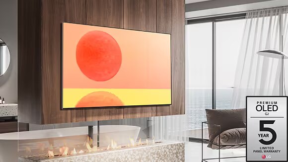 LG OLED G2 is hung on the wall in a brown and white room with red accessories