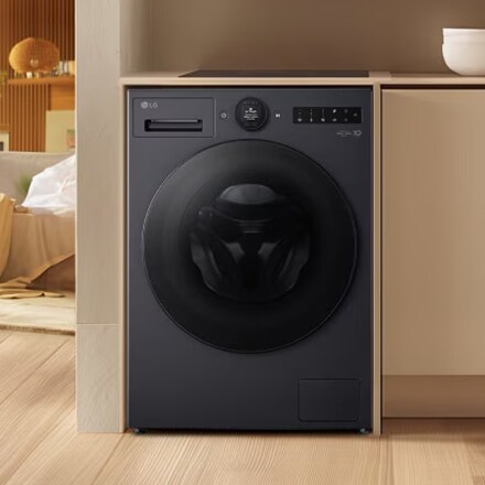A black LG washing machine is installed, blending seamlessly with the modern space.